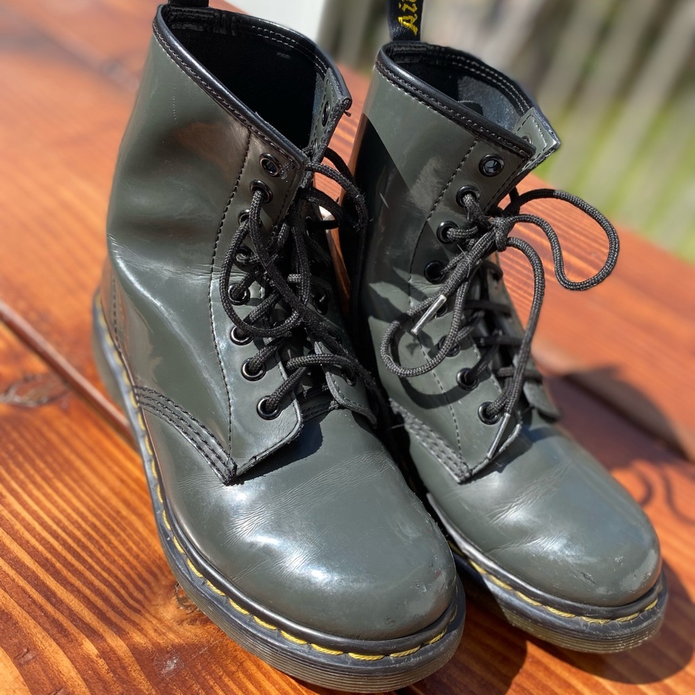 Dr. Martens the color is mix of gray and olive color. They are leather.